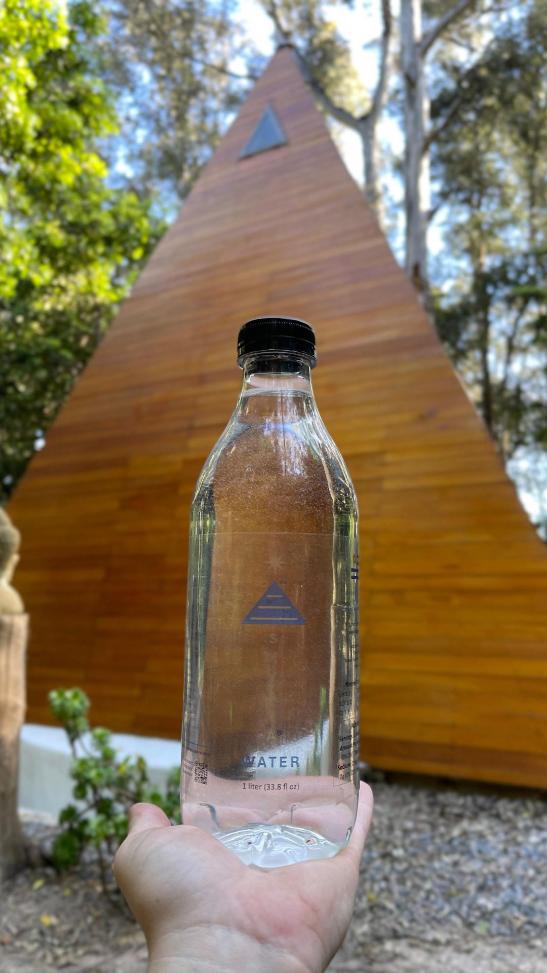 Click to view larger image Skyaia Water® bottle held in hand with pyramid structure in background